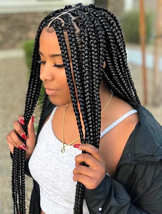 Portrait of a woman with neatly styled boho braids and curled ends