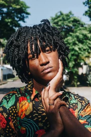 Portrait of a person with neatly maintained locs